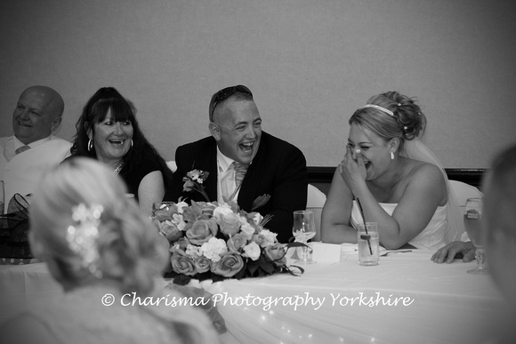 Bride & Groom having a laugh at the speeches
